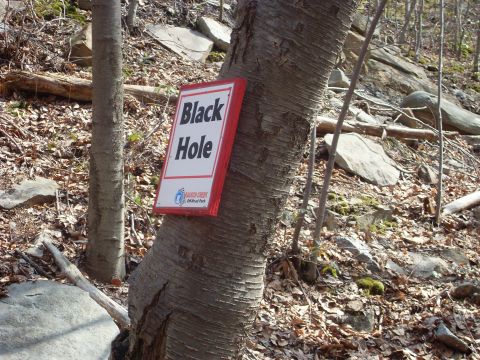 1987 Ford Bronco - A sign for "Black Hole" and "Rausch Creek Off-Road Park" is mounted on a tree in a wooded area.