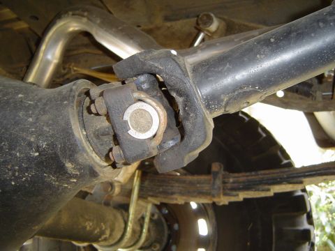 1978 Ford Bronco - Close-up view of a vehicle's driveshaft U-joint and differential, highlighting mechanical components.