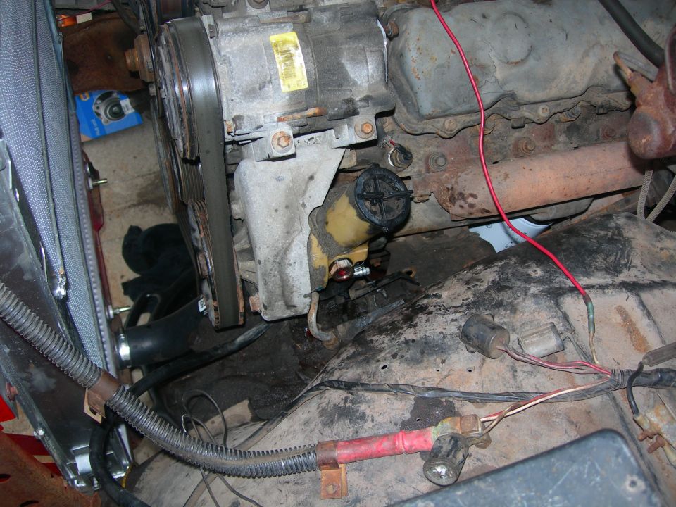 1984 Ford Bronco engine bay with power steering pump and serpentine belt.