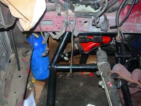 1984 Ford Bronco - This is a close-up view of the engine bay of a vehicle, likely a 1984 Ford Bronco, showing various engine components, wiring, and a blue ni…