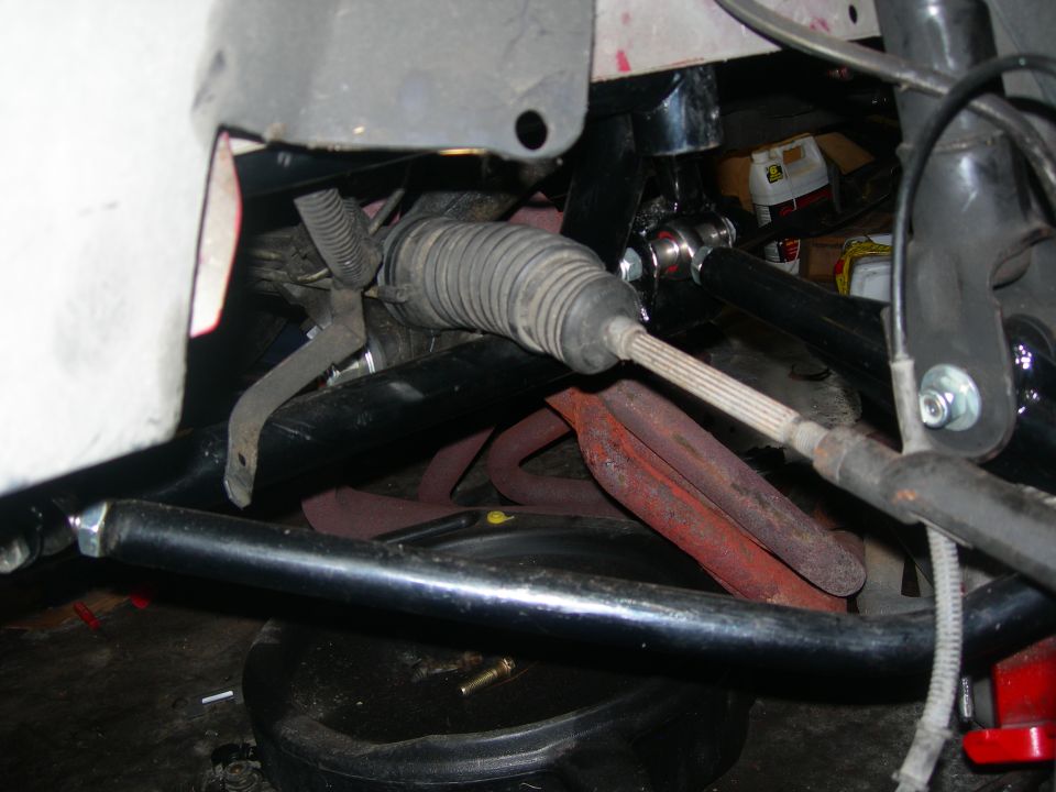Vehicle steering and suspension parts, including steering rack and tie rod.