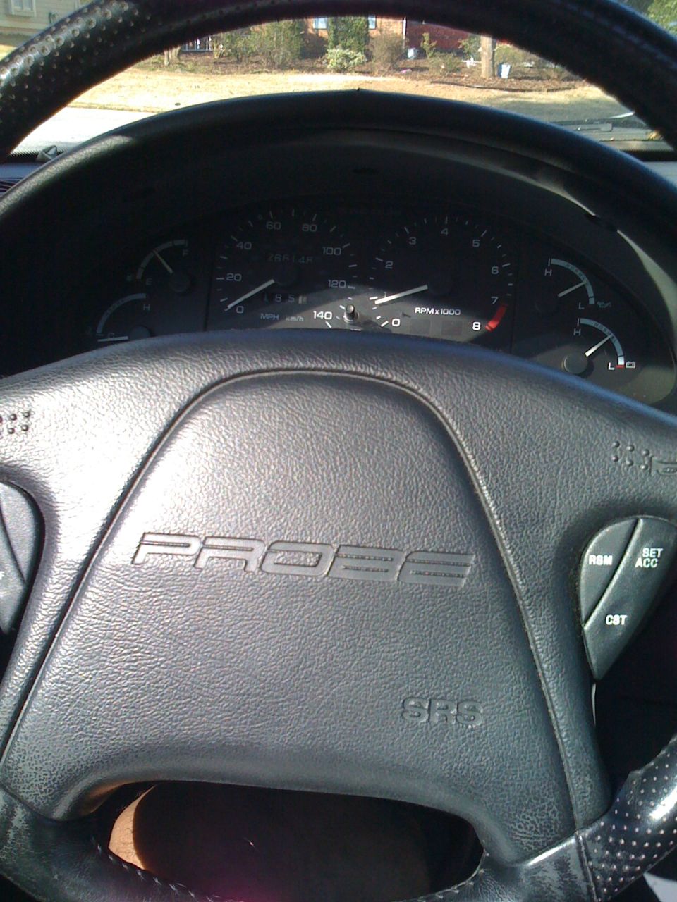 Black Ford Probe steering wheel and gauge cluster, interior view