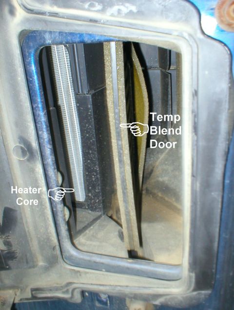 1983 Ford Bronco - This is under the hood looking rearward over the R wheelwell with the evaporator cover removed beside the R exhaust manifold. See also: [ur…