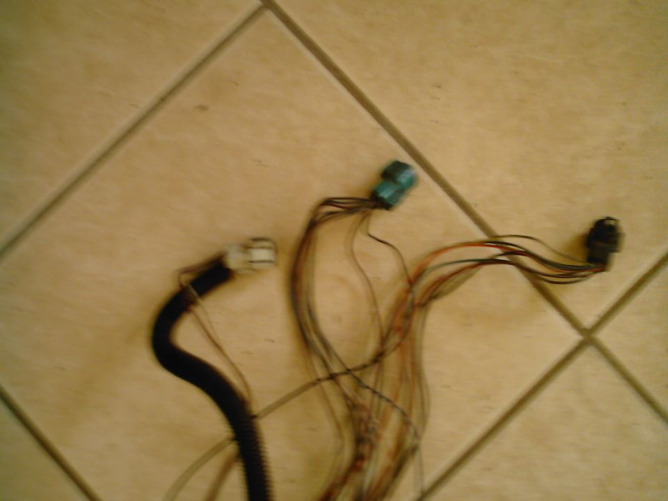 Wiring harness with three connectors on a tiled surface