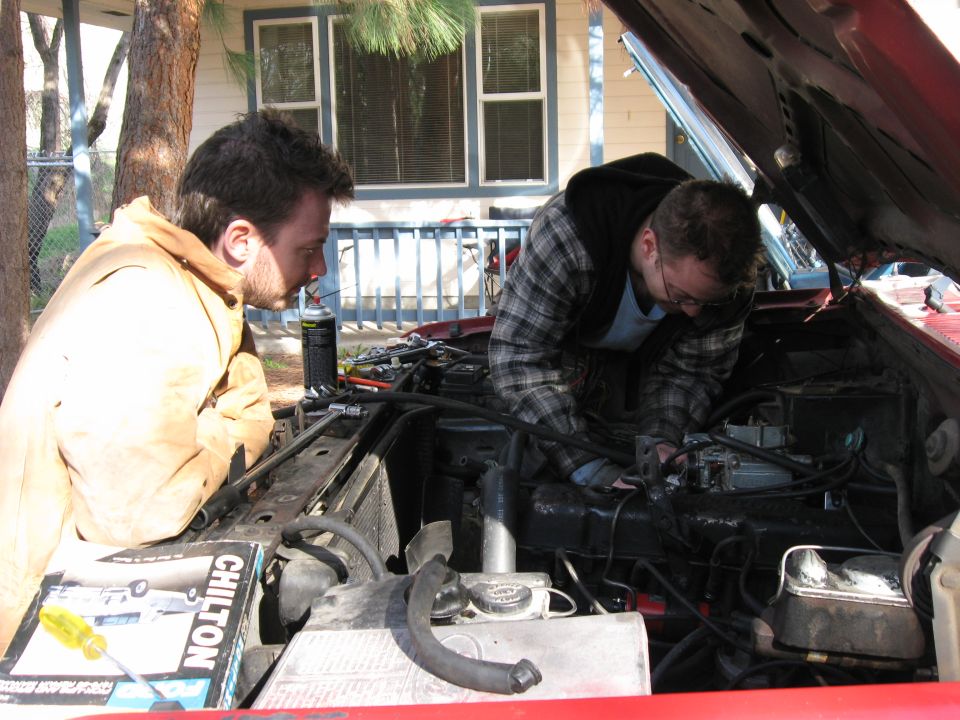 Me working away while my brother supervises.  This picture is interesting because it shows how the intake is designed to keep the carb flat even when the engine is much higher in the front than the rear.