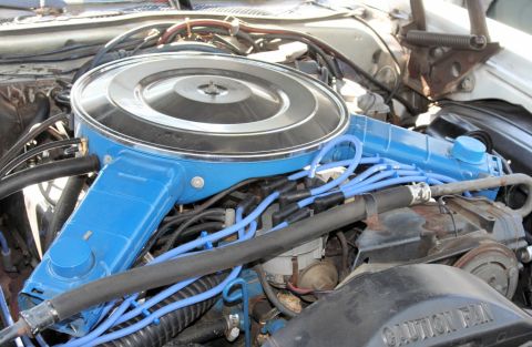 1976 Ford Ranchero - Close-up view of an engine bay, highlighting the blue air cleaner assembly and spark plug wires.