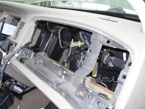 2004 Mercury Marquis - The interior of a vehicle with the dashboard removed, revealing internal components and wiring harnesses.