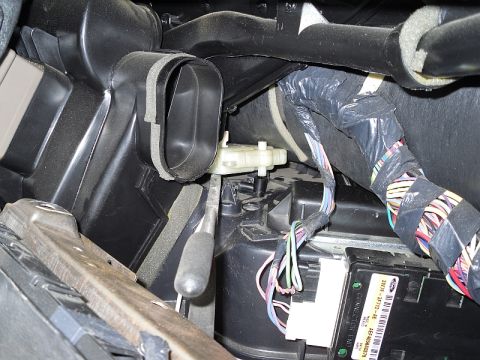 2004 Mercury Marquis - Close-up view of vehicle interior HVAC components, including ductwork and a control module.