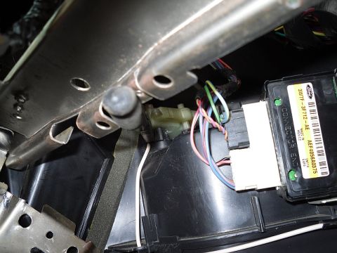 2004 Mercury Marquis - Close-up view of automotive wiring and a control module inside a vehicle's interior.