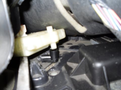 2004 Mercury Marquis - A close-up view of an interior mechanical linkage, possibly part of the HVAC or steering column system.
