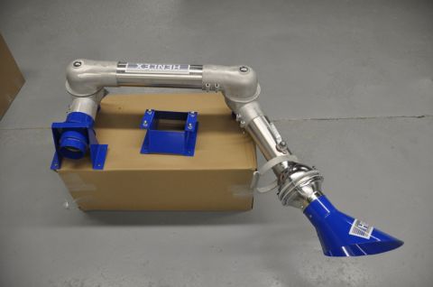 1996 Ford Bronco - A metal welding arm with blue components rests on a cardboard box in a warehouse setting.