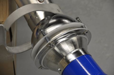 1996 Ford Bronco - Detail of a metal joint on a welding arm, springs and a blue hose attachment.