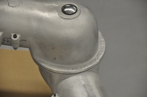 1996 Ford Bronco - Close-up of an aluminum pipe fitting showing stamped patent information.