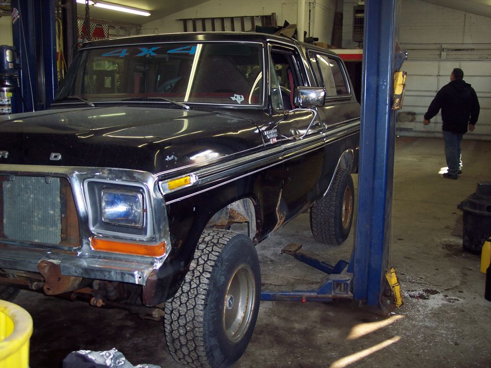 Black 1978 Ford Bronco on a hydraulic lift in a garage