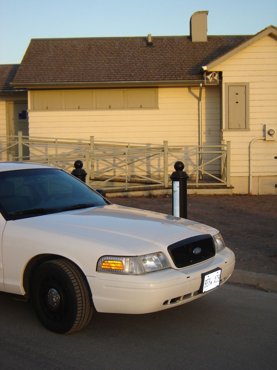 White Ford Crown Victoria sedan, front passenger side view
