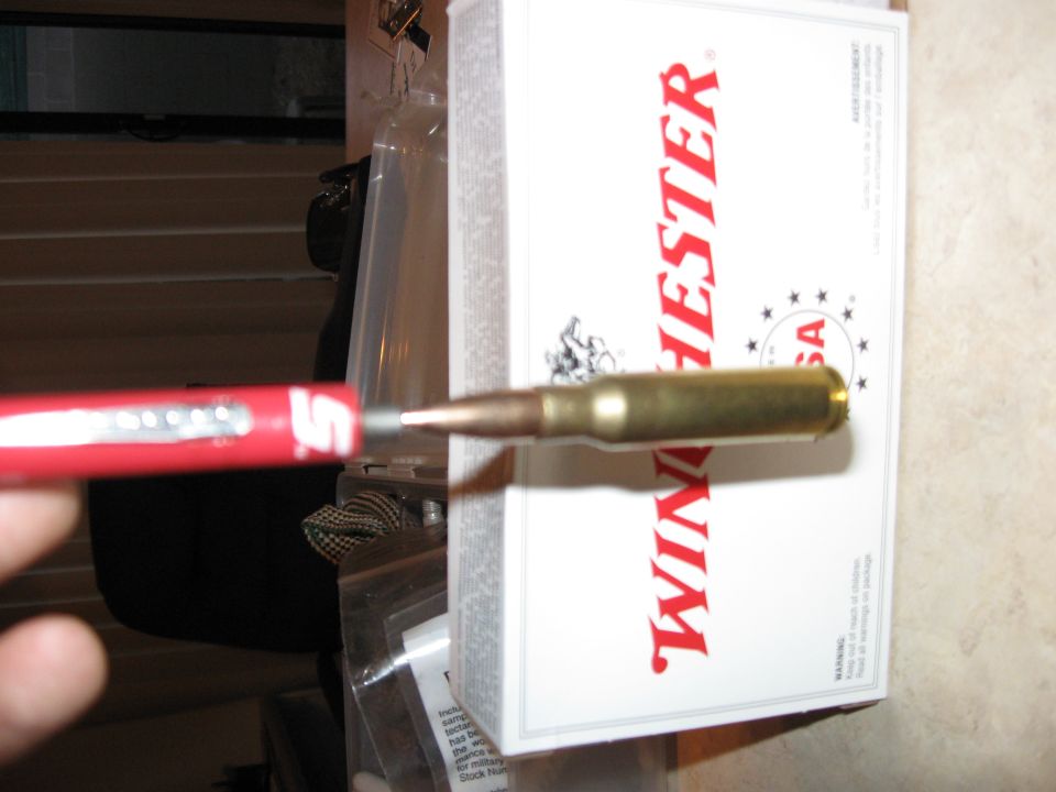 Bullet against a box of Winchester ammunition