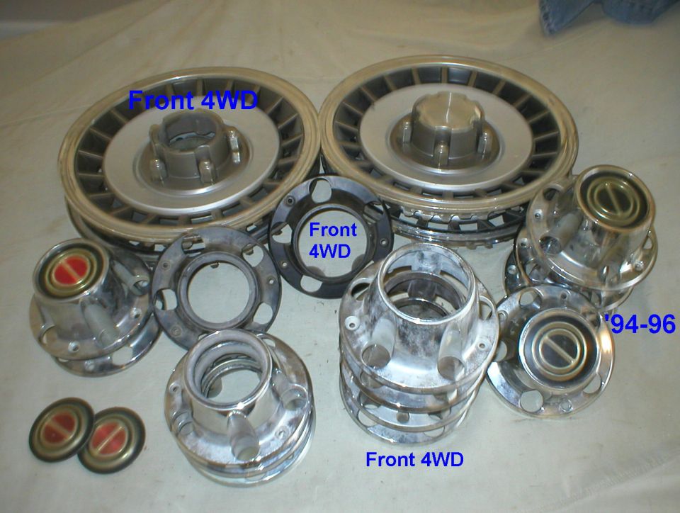 Front 4WD locking hubs, spindle parts and dial caps disassembled and labeled, including 94-96