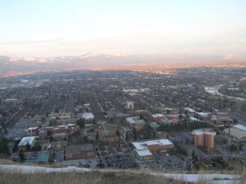 1996 Ford Bronco - An aerial view of a sprawling city with mountains in the background during sunset.