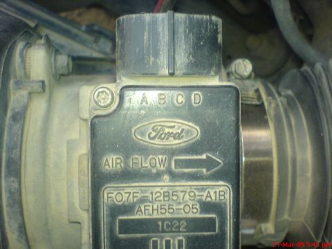1992 Ford Crown Victoria - A close-up view of a Ford mass air flow sensor with part numbers F07F-12B579-A1B and AFH55-05 visible. The sensor is dusty and mounted in a…