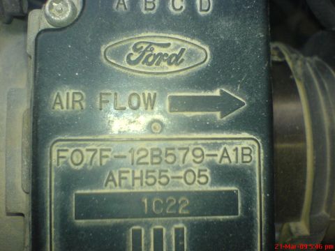 1992 Ford Crown Victoria - A close-up view of a Ford branded air flow sensor with part numbers visible. The sensor is dusty and shows an arrow indicating air flow dir…