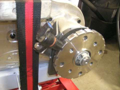 1996 Ford Bronco - A close-up view of a metal component with a circular flange and a black and red strap wrapped around it. The component appears to be part o…