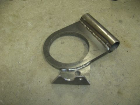 1996 Ford Bronco - A custom metal bracket with a cylindrical tube attached is shown resting on a concrete surface. The bracket features a circular opening and…