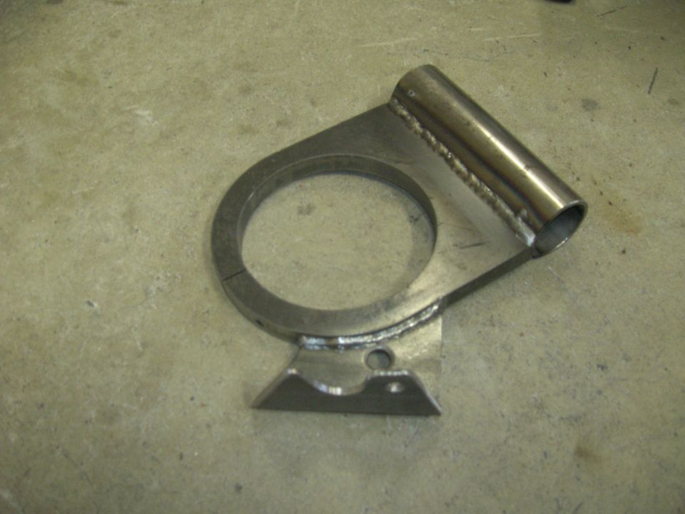 Custom metal bracket with cylindrical tube on concrete