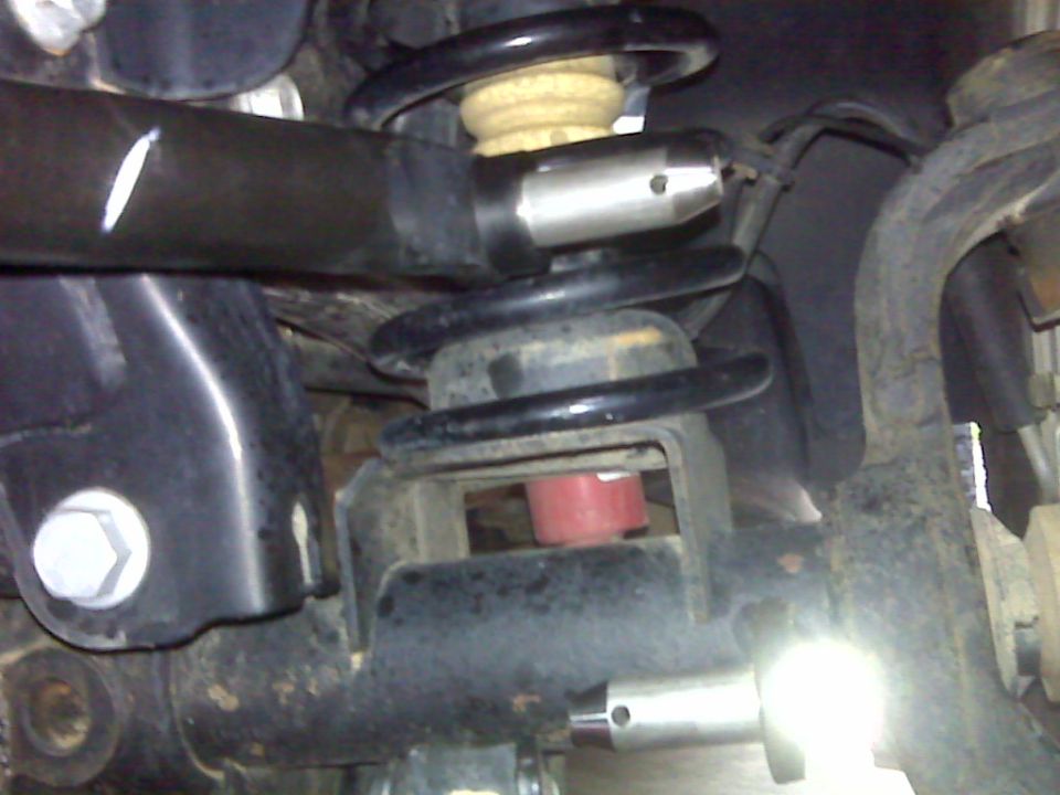 2008 Jeep Wrangler suspension components: coil spring, shock mount, control arm.