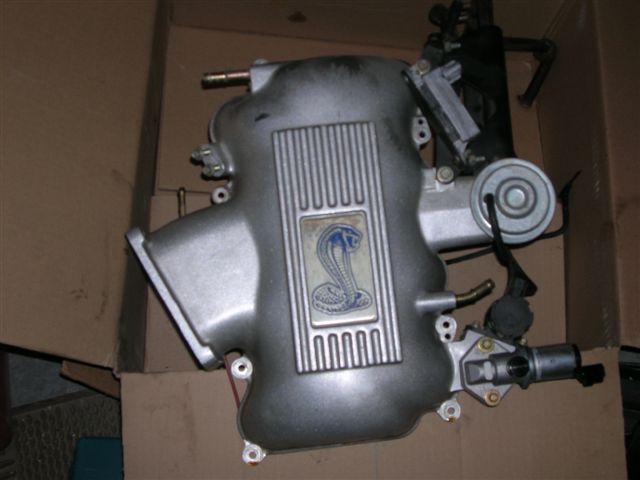 Cobra-badged supercharger intake manifold in a cardboard box