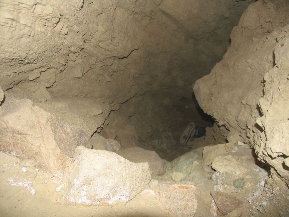 A pair of athletic shoes inside a cave.
