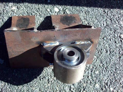 1989 Ford F-150 - Fabricated metal part with a roller bearing, likely for automotive modification.