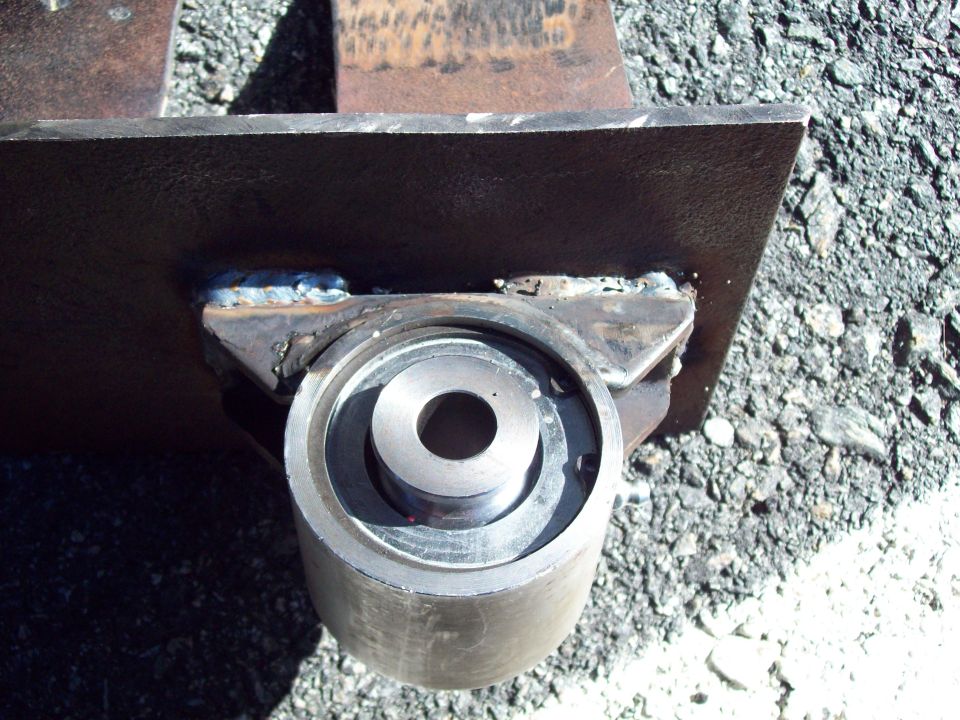 Close-up of a metal suspension component with visible welds