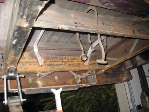 1991 Ford Bronco - Underbody view of a vehicle, focusing on the brake and clutch pedals and suspension system. Year is undetermined.