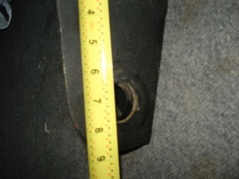 1978 Ford Bronco - A yellow measuring tape is shown against a dark, textured surface with a circular hole.