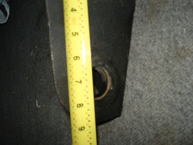 Measuring tape against a dark interior part with a circular opening