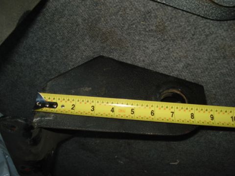 1978 Ford Bronco - A close-up view of a metal component being measured with a yellow tape measure.