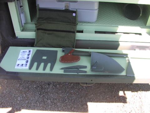 1981 Ford Bronco - Tools and a storage compartment are visible inside a vehicle.