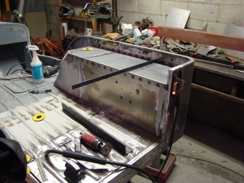 1948 Jeep Wrangler - Jeep CJ tub undergoing bodywork and restoration in a workshop setting.