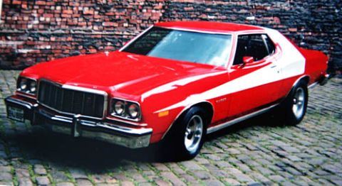 1993 Ford Bronco - A red and white 1977 Ford Gran Torino coupe is shown from a three-quarter front angle.