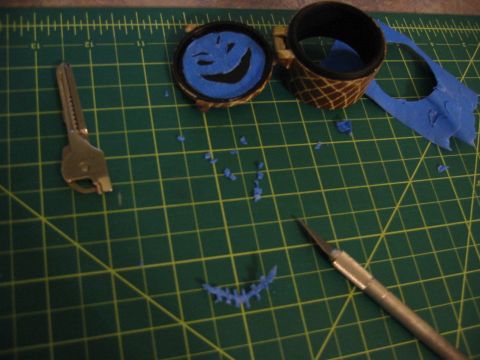 1996 Ford Bronco - A craft project is underway with a key, a smiley face, and a hobby knife on a cutting mat.
