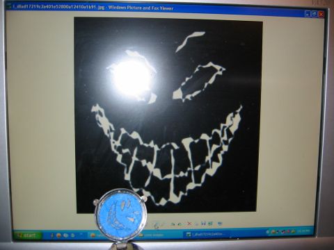 1996 Ford Bronco - A computer monitor displays a spooky jack-o-lantern face graphic. A small decorative item sits in front of the screen.