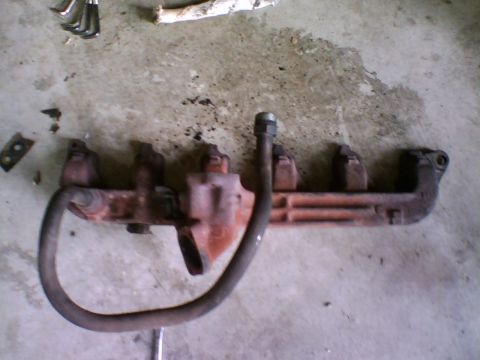 1981 Ford Bronco - A picture of the restrictive six-to-one exhaust outlet on the carbed 300. The pipe in front is the EGR pipe that routes up to the EGR space…