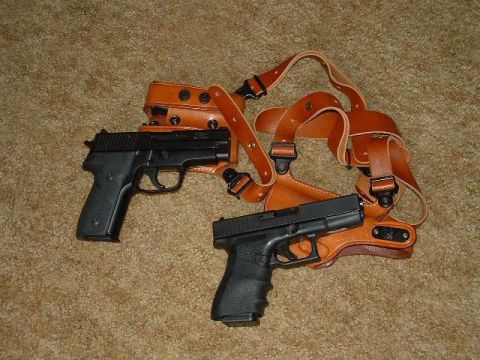 1978 Ford Ranchero - A shoulder holster is shown with two semi-automatic pistols resting on a carpeted floor.