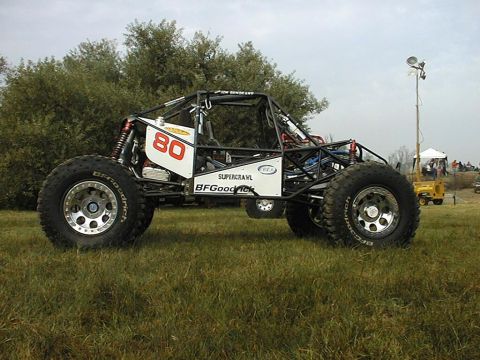 1997 Ford Ranger - Custom off-road buggy with large tires and roll cage, parked on grass.
