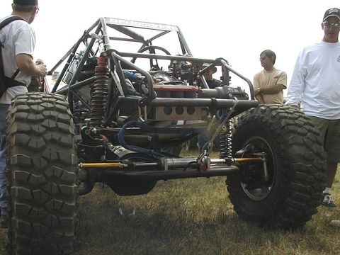 1997 Ford Ranger - Custom off-road buggy with massive tires and a prominent roll cage is displayed outdoors.