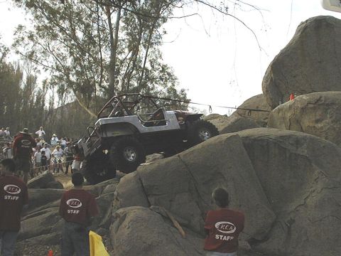 1997 Ford Ranger - A modified Jeep navigates a challenging rocky terrain during an off-road event.