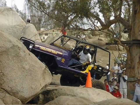 1997 Ford Ranger - An off-road vehicle with "OFF ROAD GENERAL STORE" branding navigates a rocky obstacle course.