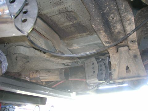 1996 Ford Bronco - The underbody of a vehicle is shown, focusing on the exhaust system and suspension parts.