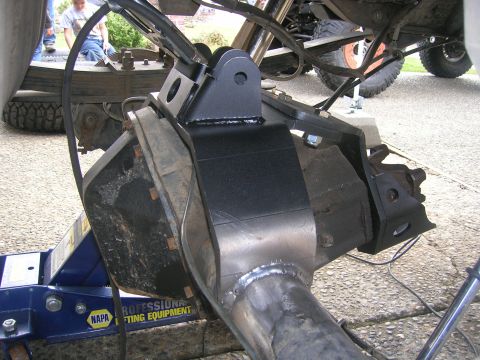 1996 Ford Bronco - Detail of a vehicle's rear suspension component, likely a shock absorber or differential housing.
