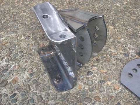 1996 Ford Bronco - Various vehicle components are scattered on a gravelly surface, suggesting a disassembled or discarded part of a vehicle.